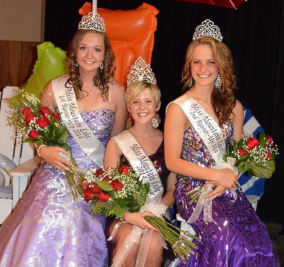 THE 2014 MISS Mountain Lake Royal Court relax under a beach umbrella following the pageant. Miss Mountain Lake Jenny, center, is surrounded by, at left, First Runner-Up Melanie Adrian and at right, Second Runner-Up Lydia Hildebrandt.