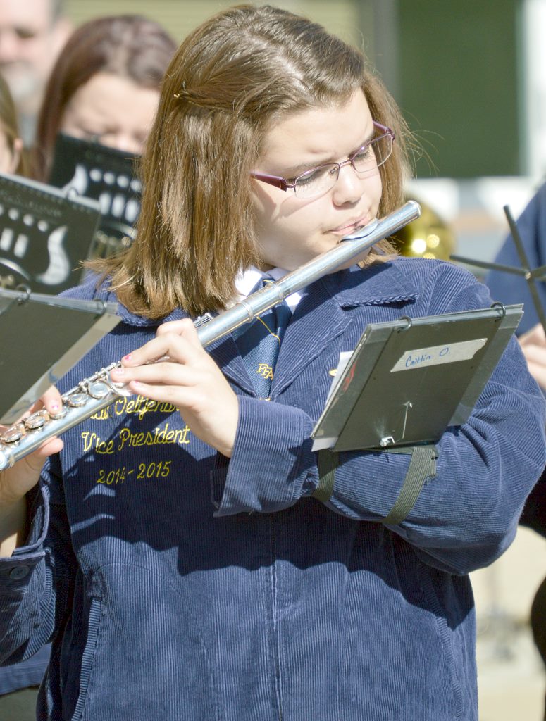 Caitlin Oeltjenbruns playing in National FFA Band on opening day of convention with their grand entrance 