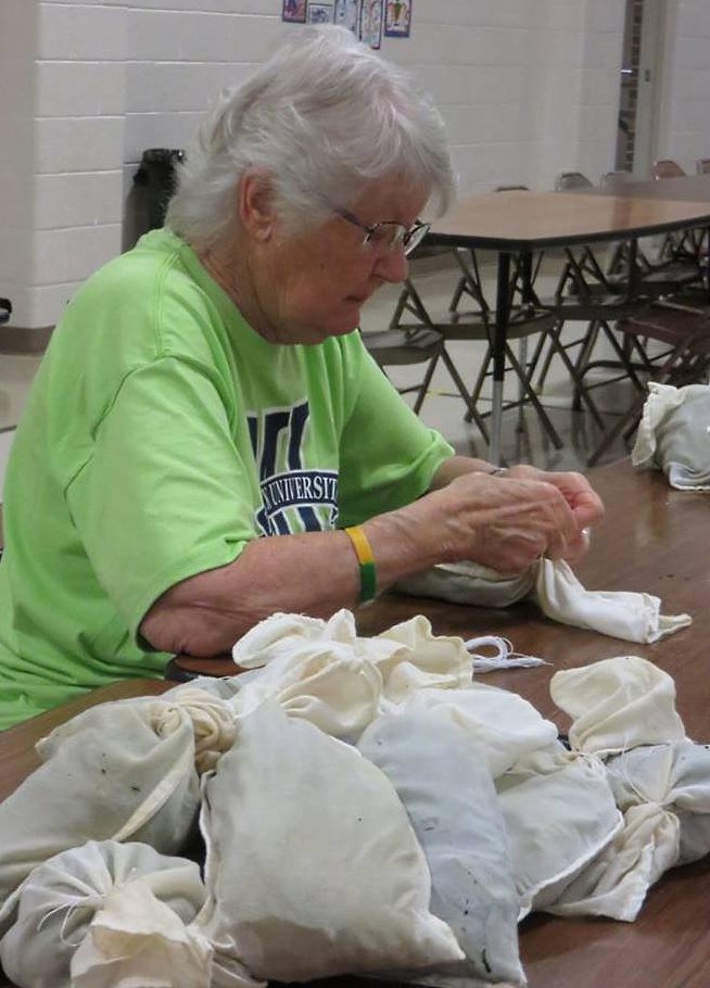 GENEVA STOESZ FILLING the seasoning packets for each of the 30 canners of borscht made and served each year. (Photo courtesy of Dee Stoesz)