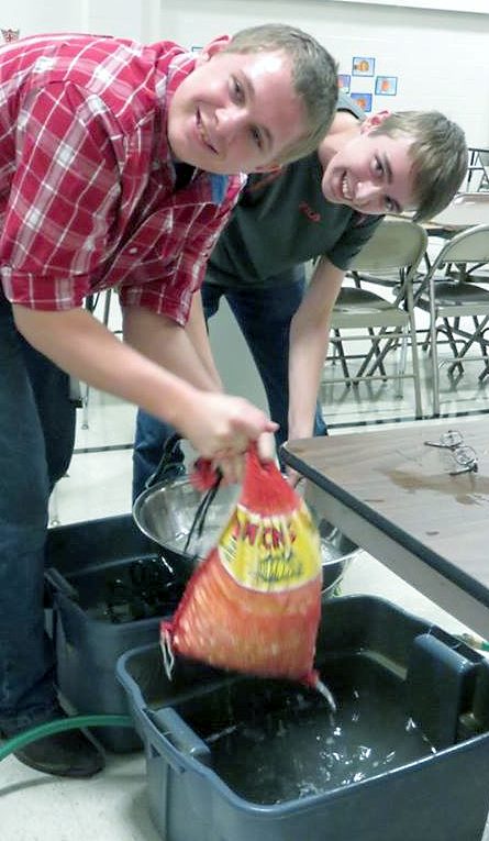 CLEANING THE POTATOES for peeling. At left is Dustin Klassen, and at right, Carter James. (Photo courtesy of Dee Stoesz)